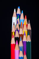Image description: tight cluster of sharpened colored pencils, points up, on a back background

Photo credit: engin akyurt on Unsplash